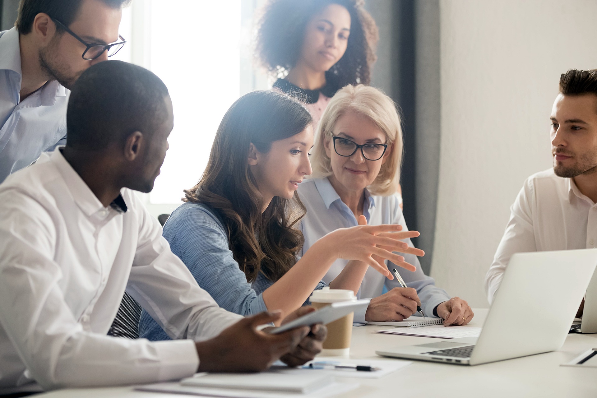 Diverse team of professionals having a collaborative discussion during a business meeting.